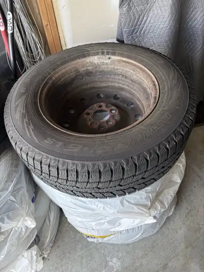 These pre-owned winter tires in size 215/70R16. The tires are mounted on steel rims, showing some su...