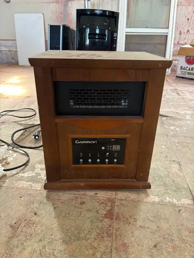Warm up your space with this Garrison infrared quartz heater, featuring 1500 watts of power and a bu...