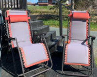 Two Red Matching Gravity Chairs 