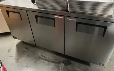 This is a used True refrigerator with a stainless steel finish and three doors, perfect for commerci...