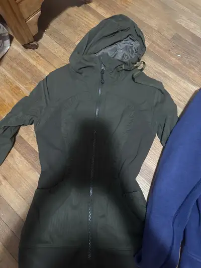 both jackets are size 2, green one fits tighter and thinner, blue one is thicker and a bit looser. i...
