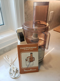 Vintage Moulinex food processor with parts and book, still works