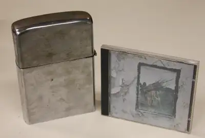 Shown in the first picture with a standard CD case for size comparison. Working flint, but needs lig...
