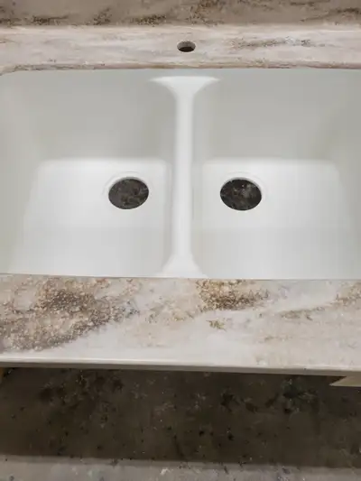 Former display model, ready for installation. L shaped Corian countertop with coved backsplash and s...