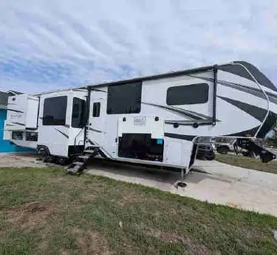 Experience luxury on the road with this 2024 Grand Design Solitude 390RK, featuring a spacious rear...