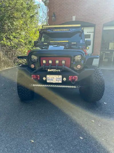 Fully customized low mileage Jeep wrangler. Custom suspension, exterior, wheels, exhaust, gauges, na...