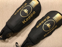 A pair new Kappa black shin guards with total ankle