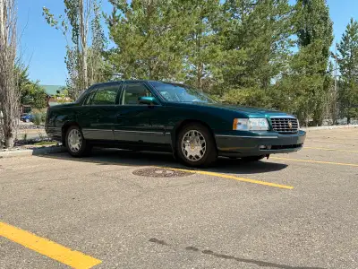 Behold, the 1997 Cadillac Deville Concours! This isn't just a car; it's a meticulously preserved tim...