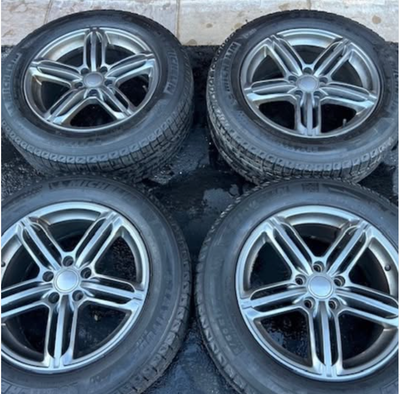 A complete set of four Michelin Latitude X-Ice winter tires (235/60R17) mounted on Mercedes-Benz rim...