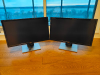A pair of identical Dell 24 inch monitors