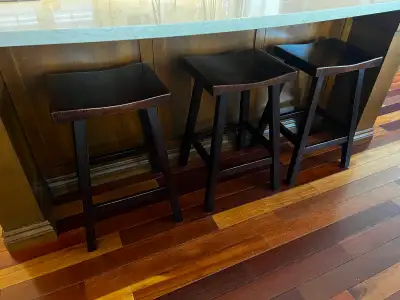 3 Mahogany coloured solid wood saddle style counter stools, View more