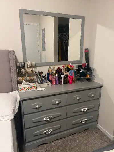 Elevate your bedroom with this stunning dresser and wall-mounted mirror set! The dresser features si...