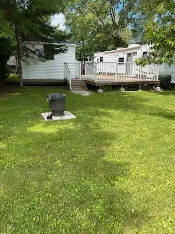 2011 Hideout trailer, included 12x12 gazebo and deck. 2 bedrooms with queen size beds, kitchen and d...