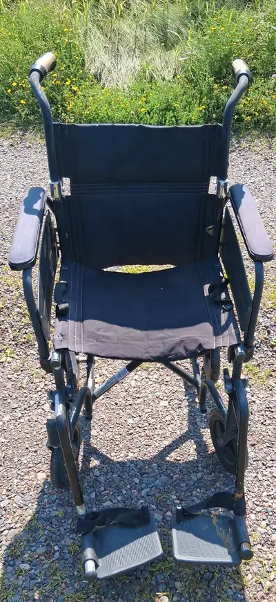 Transport chair With leg braces.It's in good shape everything works on it and it folds up for transp...