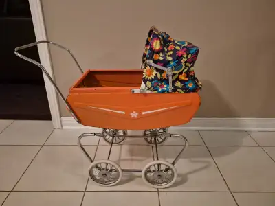 Vintage toy doll carriage/ pram 1970s. Thistle brand . Solid orange metal base with blue plastic cov...