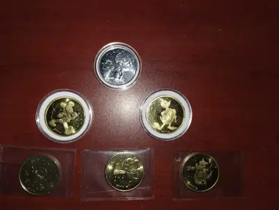 Disney's 100th & 50th anniversary coins, View more