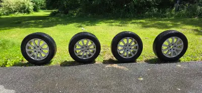 Durable Michelin X-Ice winter tires in size 205/65R15. These tires are mounted on silver multi-spoke...