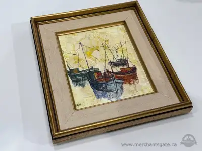 Vintage framed nautical painting featuring a small harbor scene with several fishing boats. The artw...