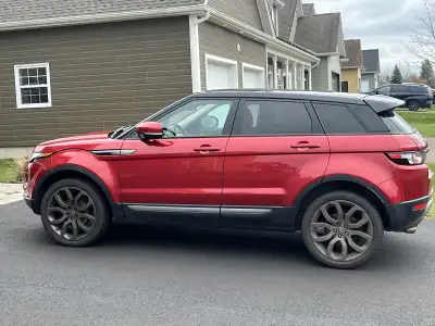 2013 Range Rover Evoque. Firenza Red with black roof and black leather interior. The entire roof is...