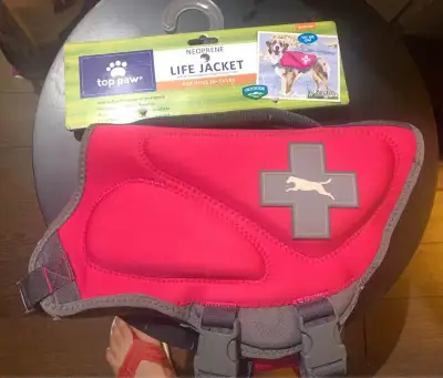 Brand new size medium dog life jacket. Hot pink with adjustable straps. Bought brand new from petsma...