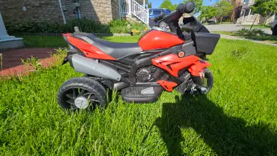 Red and black electric ride-on toy motorcycle with songs and headlight. Suitable till 4.5 years age....