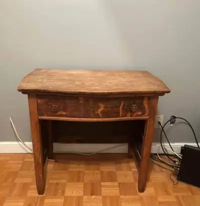 This is an antique wash stand or desk with a drawer, perfect for adding a vintage touch to your home...
