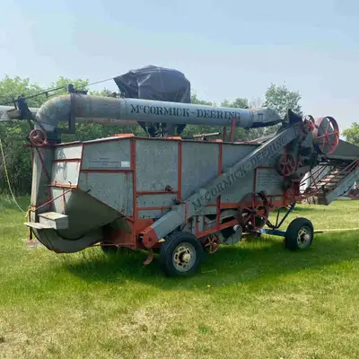 Threshing machine in good working condition. Comes with all belts and two drive belts. Wheels on rub...