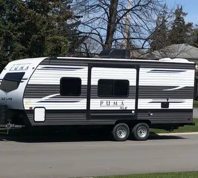 For sale: 2021 Puma XLE Lite 21FBC Trailer has Power awning, jack, stabilizers, and slide. Brand new...