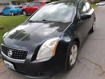 This 2007 Nissan Sentra is a reliable sedan that is perfect for commuting or as a dependable daily d...