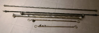 Lot of curtain rods in different sizes including 1 shower curtai