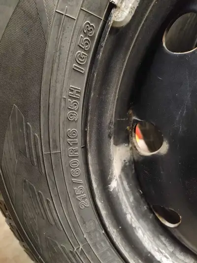 Set of four 215/60R16 IceGuard winter tires mounted on black steel rims with 5 bolt pattern. These w...