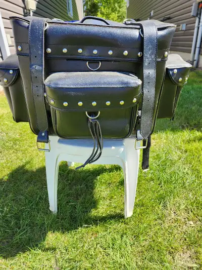 Leather, fastens around backrest; Smaller piece fits on top of larger piece