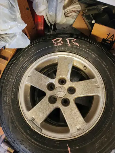 For sale is a set of four P215/70R16 Goodyear winter tires mounted on Mitsubishi rims, suitable for...