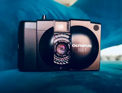 The Olympus XA1, introduced in 1982, was a fixed-focus point-and-shoot and the simplest of the clams...