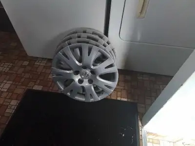 These are a set of four Mazda hubcaps, perfect for replacing lost or damaged ones. They are in used...