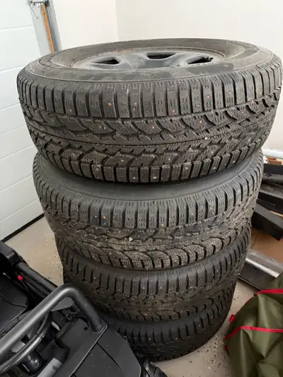 I'm selling a set of four 17” steel Jeep wheels with 265/70 R17 Firestone Winterforce studded tires....
