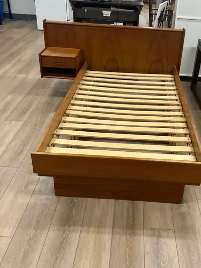 This beautiful, authentic mid-century modern teak bed frame features a built-in headboard with an in...