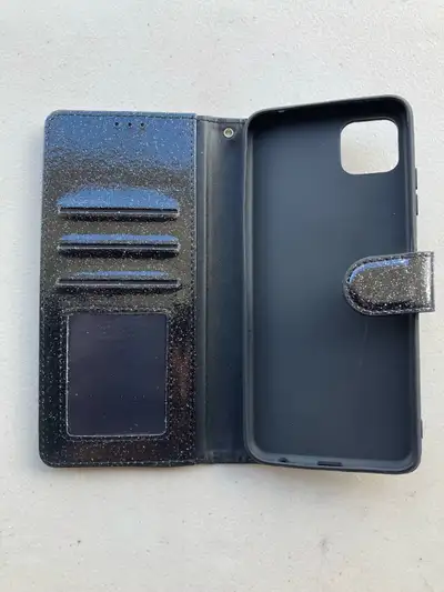 This is a cute black glitter iPhone 11 wallet case with a magnetic closure. It has card slots, and a...