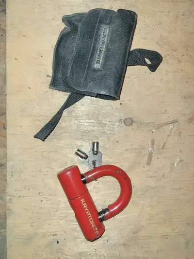 Keep your morcycle or bicycle safe with this used red Kryptonite bike lock, designed to withstand th...