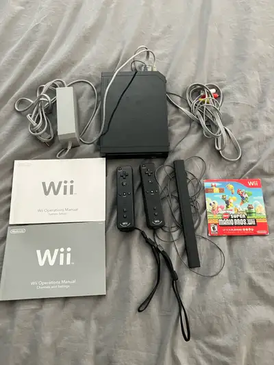 Selling a used Nintendo Wii console, complete with two Wii remotes, sensor bar, power adapter, AV ca...