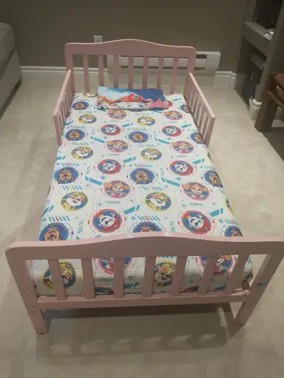 Full size toddler bed in very good condition (light pink). Comes with a reversible memory foam mattr...