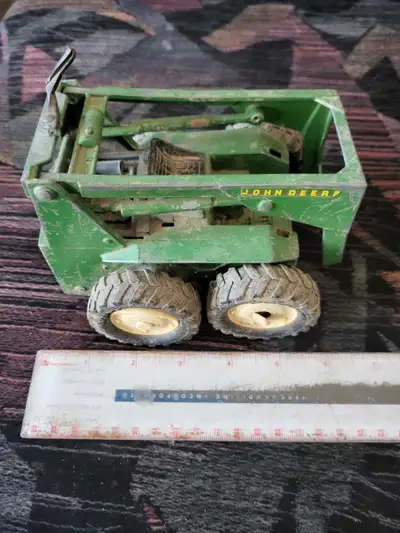 Vintage Ertl John Deere skid Steer Toy for parts or repair. The bucket is broken off and missing as...