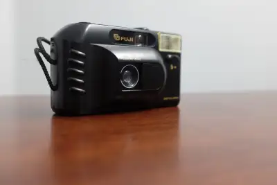 Fixed focus 35mm point-and-shoot camera released by Fuji in the 80's. DL stands for "drop-in loading...