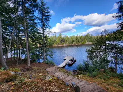Beautiful waterfront off grid cabin on very private lake for sale. Enjoy this water access cottage o...