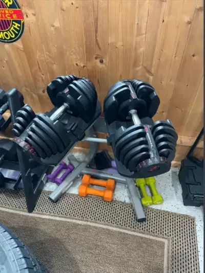Bowflex 1090 adjustable dumbbells with bowflex stand. Weights on these can be adjusted between 10 an...