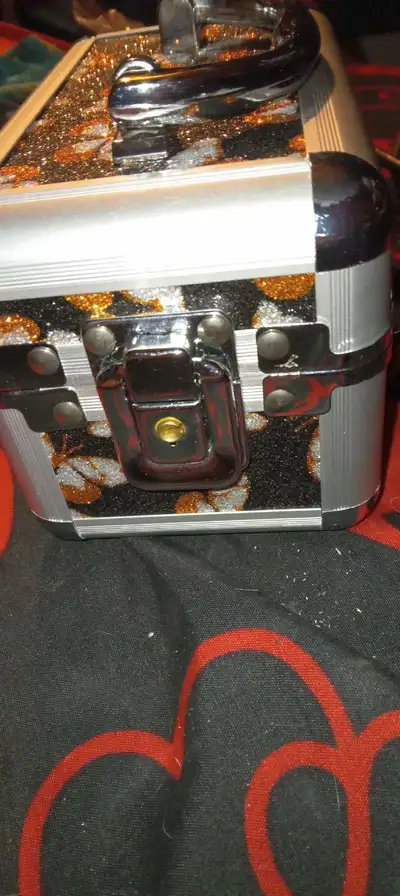 This is a used jewelry box with a mirror inside. It is decorated with butterflies and is purple on t...