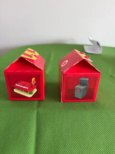 Selling two unique McDonald's Happy Meal boxes, one showcasing the classic McDonald's restaurant and...