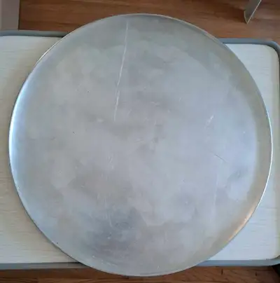This pizza pan is ready to help you make some delicious pies! It's a sturdy, used pan that has seen...