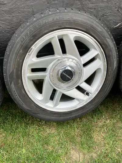 * 16" Camaro OEM 4th gen Rims, center caps and 4 Dunlop Graspic winter tires, 205/55R16. Located in...