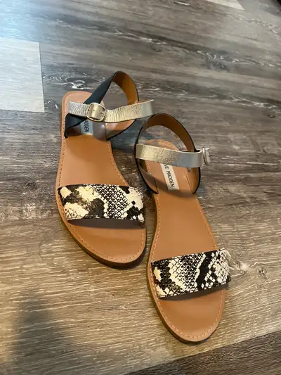 These are used Steve Madden sandals in a size 7. The stylish snake skin print will make these a fun...